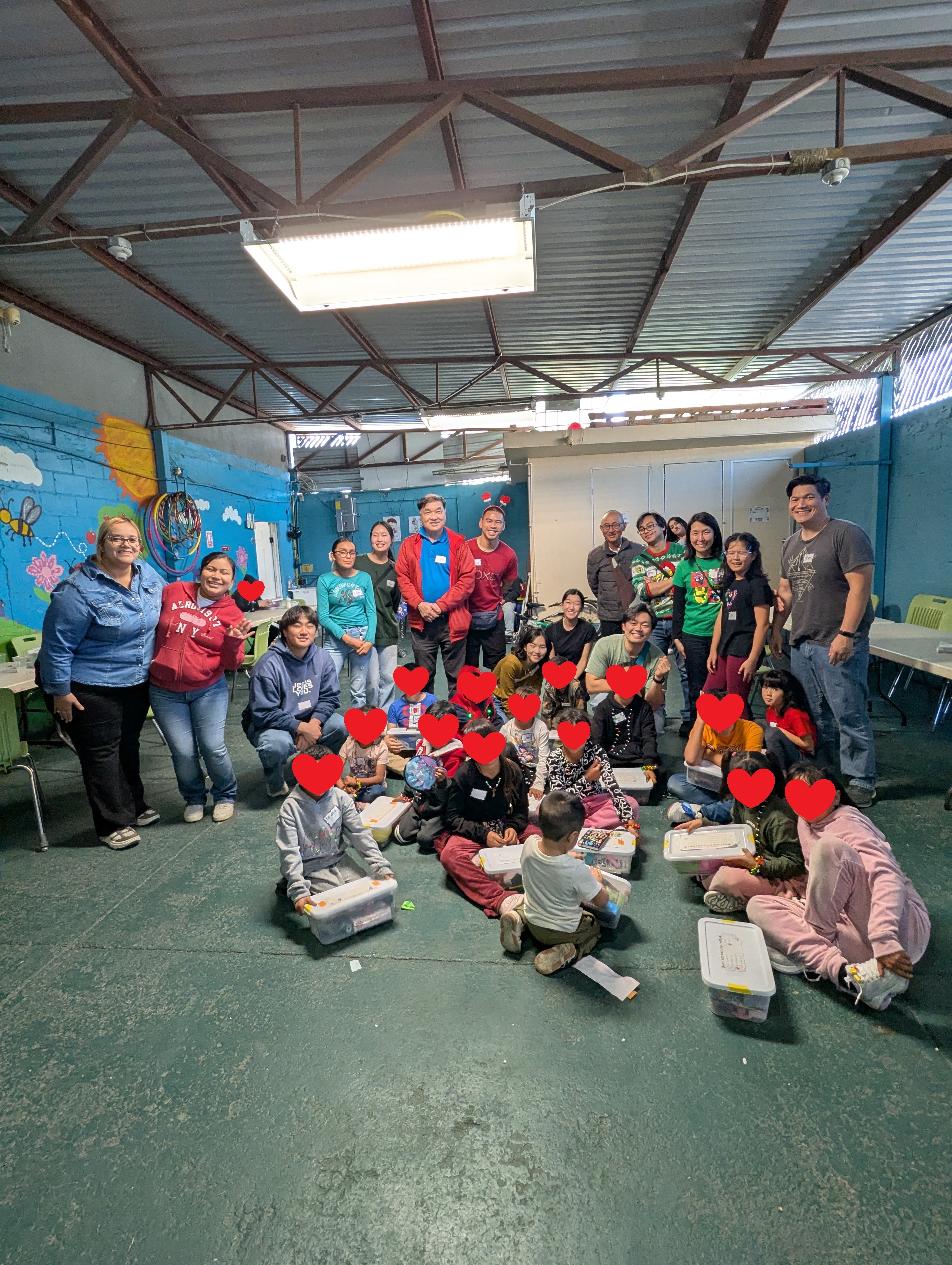 Renewal Missions volunteers and children gathered with Christmas gift bins in a community center during the December 19 Tijuana day trip
